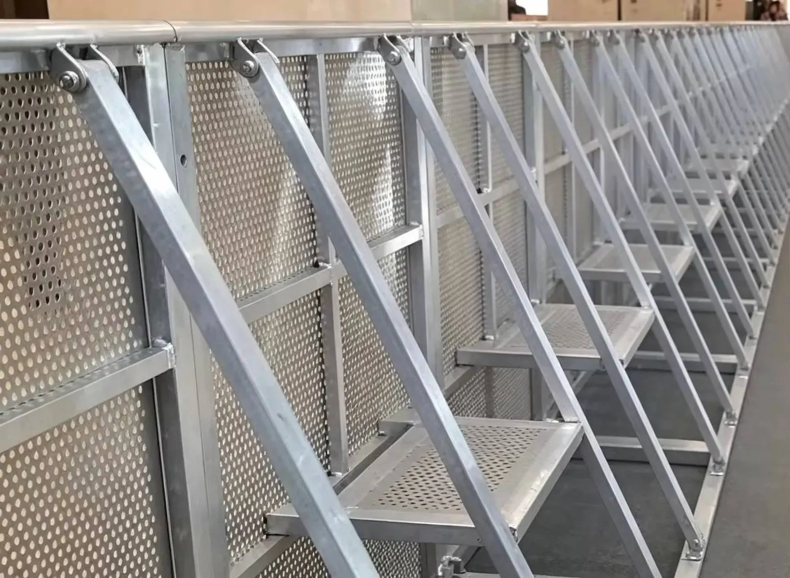 A line of stage barrier sections seen from behind, showing the braces and platform steps